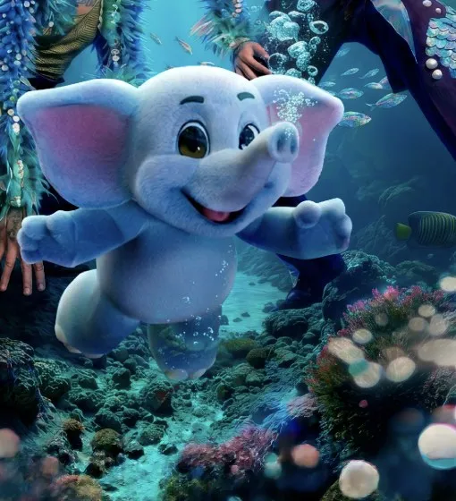 La mascota del Circo Kai: un elefante blanco y celeste flotando entre corales.